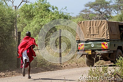 Masai tribe traditional dressed young man running Editorial Stock Photo