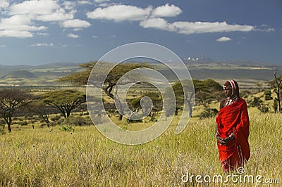 Masai Warrior in red surveying landscape of Lewa Conservancy, Kenya Africa Editorial Stock Photo