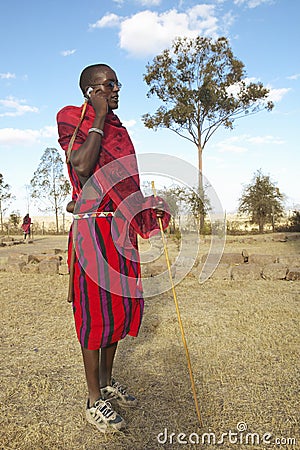 Masai Warrior using cell phone in village of Nairobi National Park, Nairobi, Kenya, Africa Editorial Stock Photo