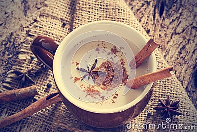 Masala chai tea with spices and star Anise, cinnamon stick, peppercorns, on sack and wooden background Stock Photo