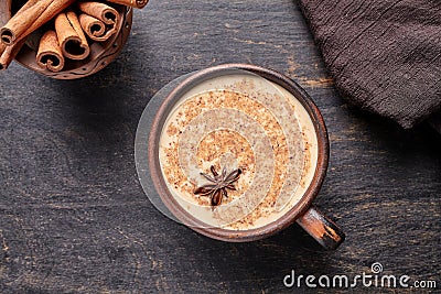 Masala tea chai latte traditional warm Indian sweet milk spiced drink, ginger, cinammon sticks, fresh spices blend Stock Photo