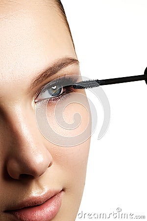 Mascara applying closeup, long lashes. Mascara brush. Eyelashes Stock Photo