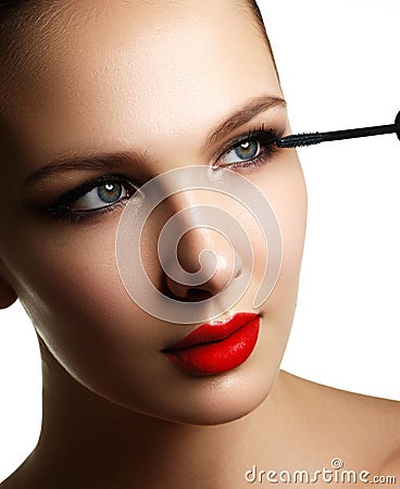 Mascara applying closeup, long lashes. Mascara brush. Eyelashes Stock Photo