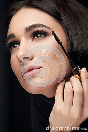 Mascara Makeup. Beauty Model Putting Black Mascara On Eyelashes Stock Photo