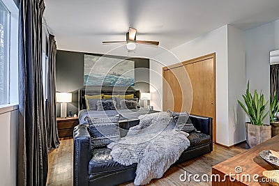 Masculine bedroom features gray accent wall Stock Photo