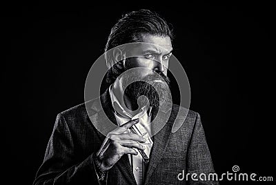 Masculine perfume, bearded man in a suit. Male holding up bottle of perfume Stock Photo