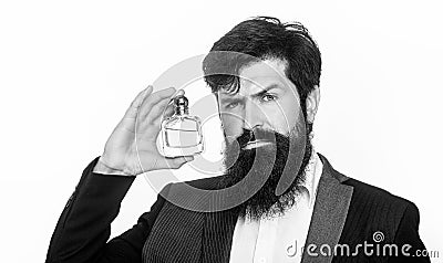 Masculine perfume, bearded man in a suit. Male holding up bottle of perfume. Closeup portrait. Black and white Stock Photo