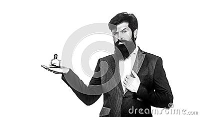 Masculine perfume, bearded man in a suit. Male holding up bottle of perfume. Man perfume, fragrance. Perfume or cologne Stock Photo