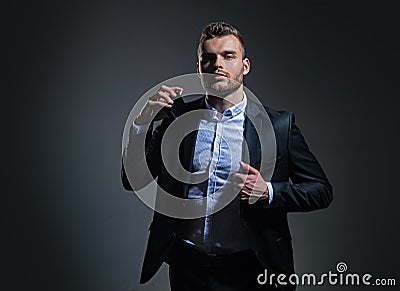 Masculine perfume. Fragrance. Male fragrance and perfumery, cosmetics. Man holding up bottle of perfumery. Cologne Stock Photo