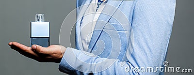 Masculine perfume. Male holding up bottle of perfume. Man perfume, fragrance. Perfume or cologne bottle and perfumery Stock Photo