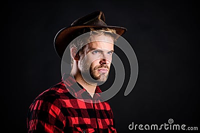 Masculinity and brutality concept. Adopt cowboy mannerisms as a fashion pose. Man unshaven cowboy black background Stock Photo