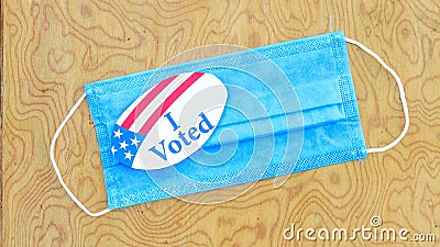 Mask with I voted sticker on table Stock Photo