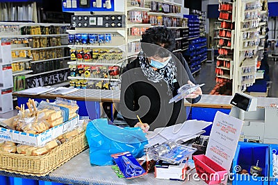 Masked assistent in a hardware store Editorial Stock Photo