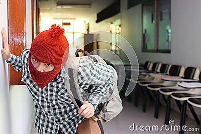 Masked burglar with bags entering into house ready to commit crime Stock Photo