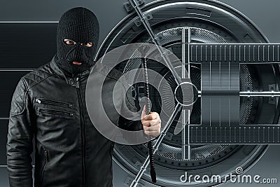 Masked burglar with crowbar in the background. Bank vault doors, large safe, bank robbery. The concept of deposit protection, Stock Photo