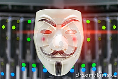Masked Hacker in Computer Server room Concept . Editorial Stock Photo