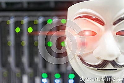 Masked Hacker in Computer Server room Concept . Editorial Stock Photo