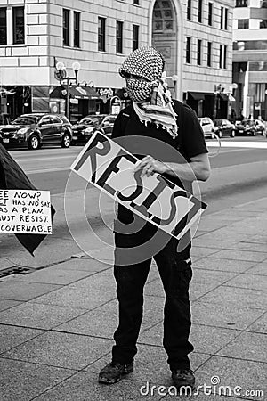 Masked Protestor Holds Resist Sign at anti-Trump Rally Editorial Stock Photo