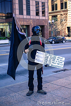 Masked Protestor Holds Resist Sign at anti-Trump Rally Editorial Stock Photo