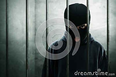 Masked thief lock in prison Stock Photo