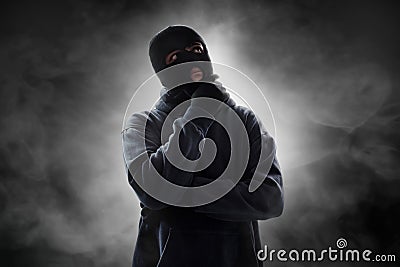 Thief thinking on smoke background Stock Photo