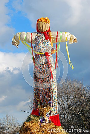 Maslenitsa doll. Blue sky with clouds background. Editorial Stock Photo