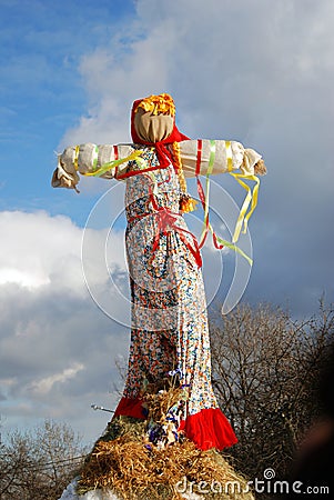 Maslenitsa doll. Blue sky with clouds background. Editorial Stock Photo