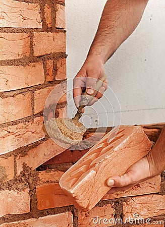 Mason hands with brick Stock Photo