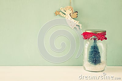 mason jar with christmas tree and flying angel Stock Photo