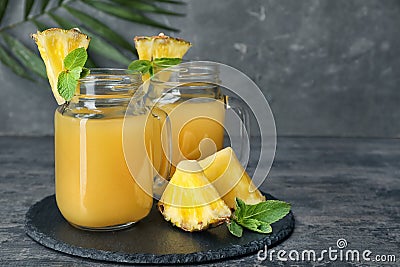 Mason jars with delicious pineapple juice Stock Photo