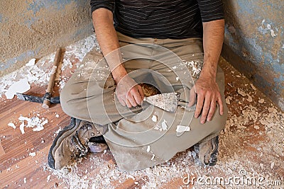 Mason man having a rest after removing paint Stock Photo