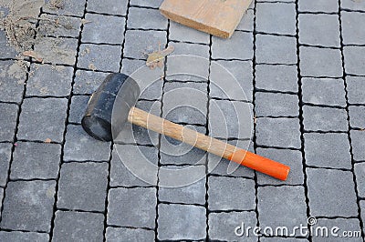 Mason tool for curb stone and brick pavement laying down, rubber mallet. rubber hammer for tile Stock Photo