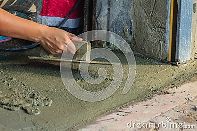 Mason worker use trowel to smooth or leveling liquid concrete of Stock Photo