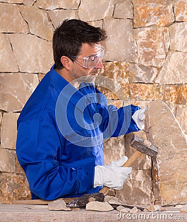 Masonry mason stonecutter man with hammer working Stock Photo