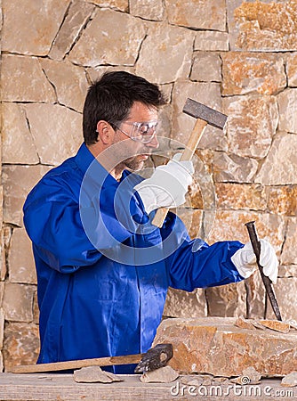 Masonry mason stonecutter man with hammer working Stock Photo