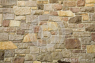 Masonry Wall of Multicolored Stone Stock Photo