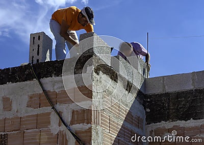Masonry worker make concrete wall by cement block Stock Photo