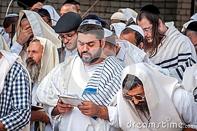 Mass prayer. Hasids pilgrims in traditional clothes. Tallith - jewish prayer shawl. Rosh Hashanah, Jewish New Year. Editorial Stock Photo