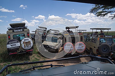 Mass tourism: Crowd of safari tourists looking for wildlife Editorial Stock Photo