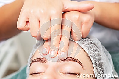 Massage of forehead of woman Stock Photo