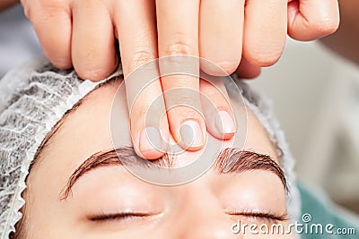 Massage of forehead of woman Stock Photo