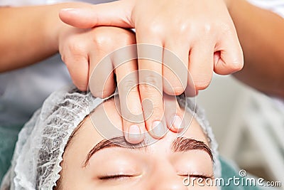 Massage of forehead of woman Stock Photo