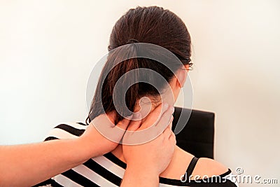 Woman having her neck massaged by a physiotherapist Stock Photo