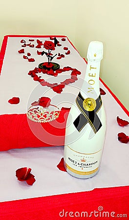 Massage table ready for VIP client. Red rose and petals. Moet champagne Editorial Stock Photo