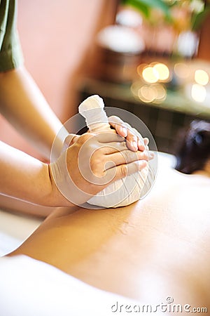 A massage therapist giving a back massage Stock Photo