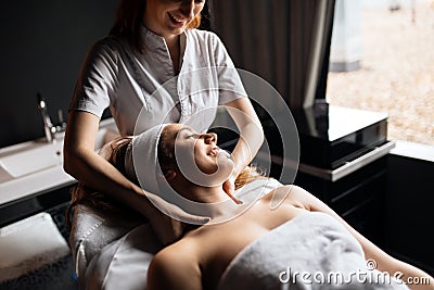 Massage therapist massaging woman Stock Photo