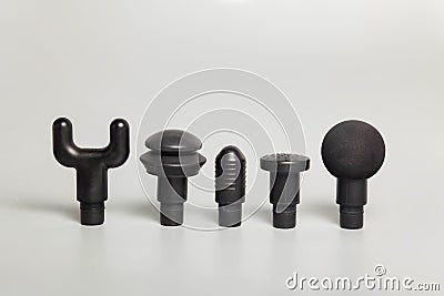 Massager attachments for handheld wireless professional therapeutic shock massage gun on gray background Stock Photo