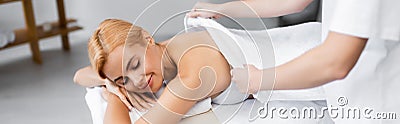 masseur covering back of pleased client Stock Photo