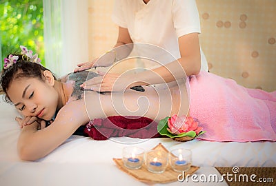 Masseur doing massage spa with treatment mud on Asian woman body in the Thai spa lifestyle, so relax and luxury Stock Photo
