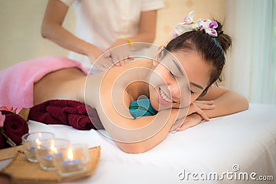 Masseur doing massage spa with treatment mud on Asian woman body in the Thai spa lifestyle, so relax and luxury. Stock Photo